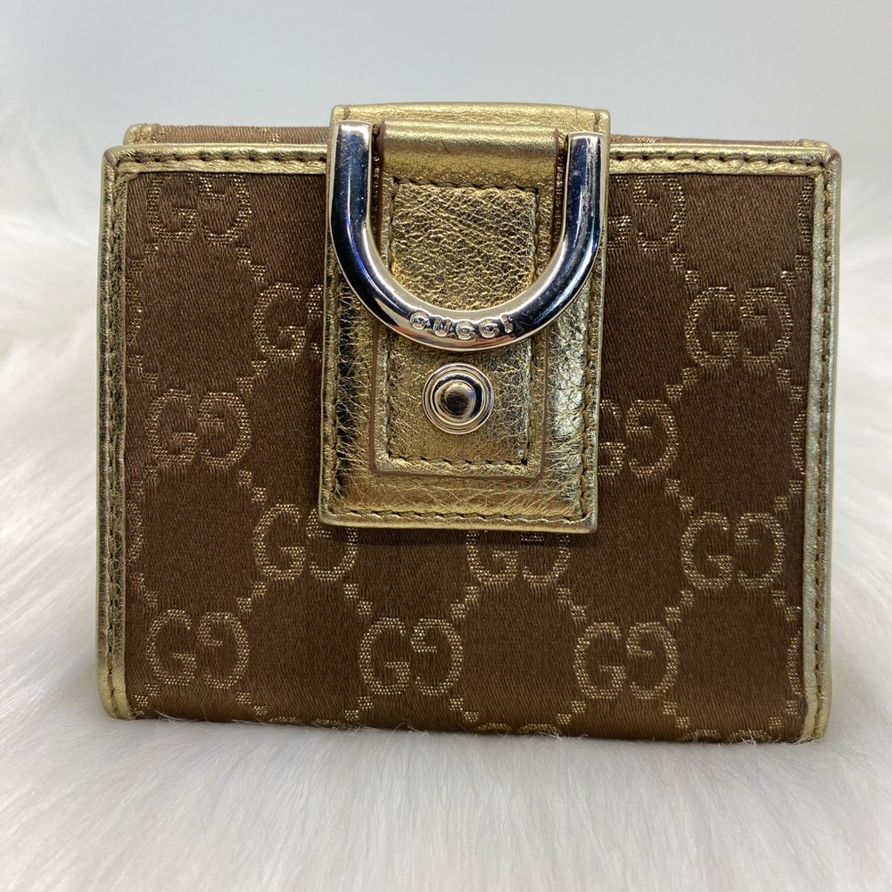 Gucci gold monogram trifolding gold canvas / leather wallet
